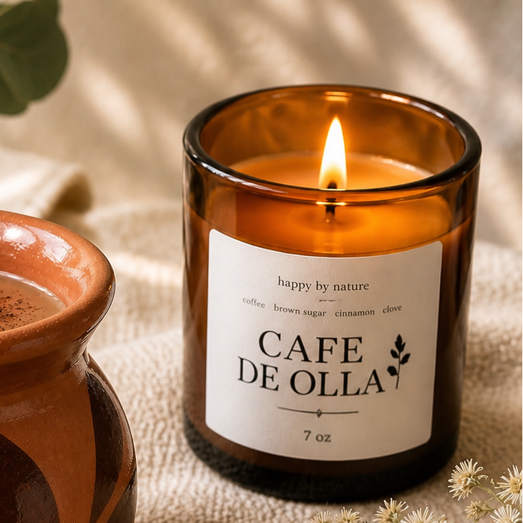 Cafe de Olla lit beside a clay mug with eucalyptus and dried florals